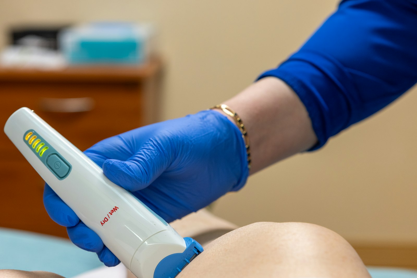 Clinician applying a radiofrequency device to a patient's face during a dermatology treatment